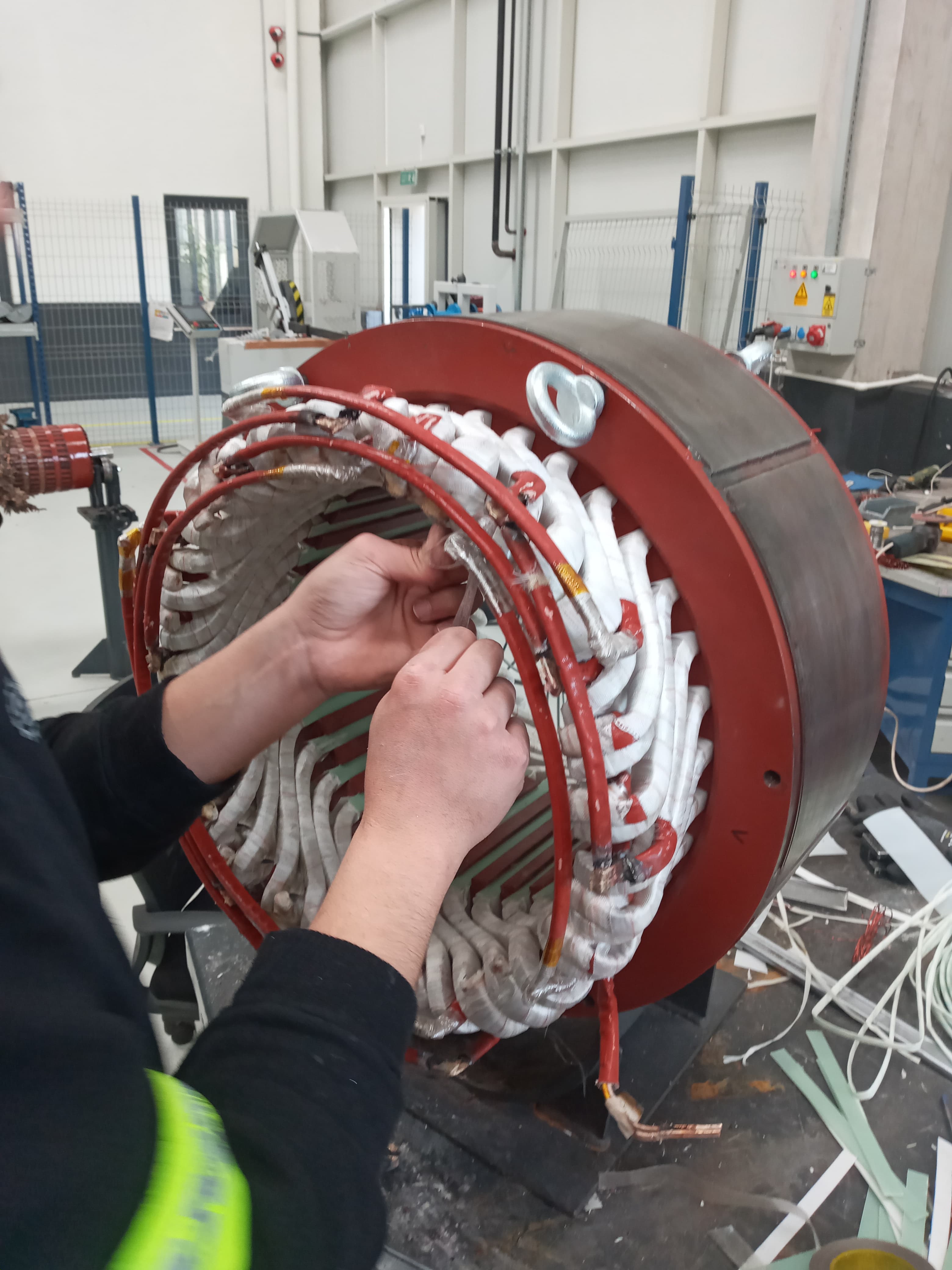 A technician working on a stator winding