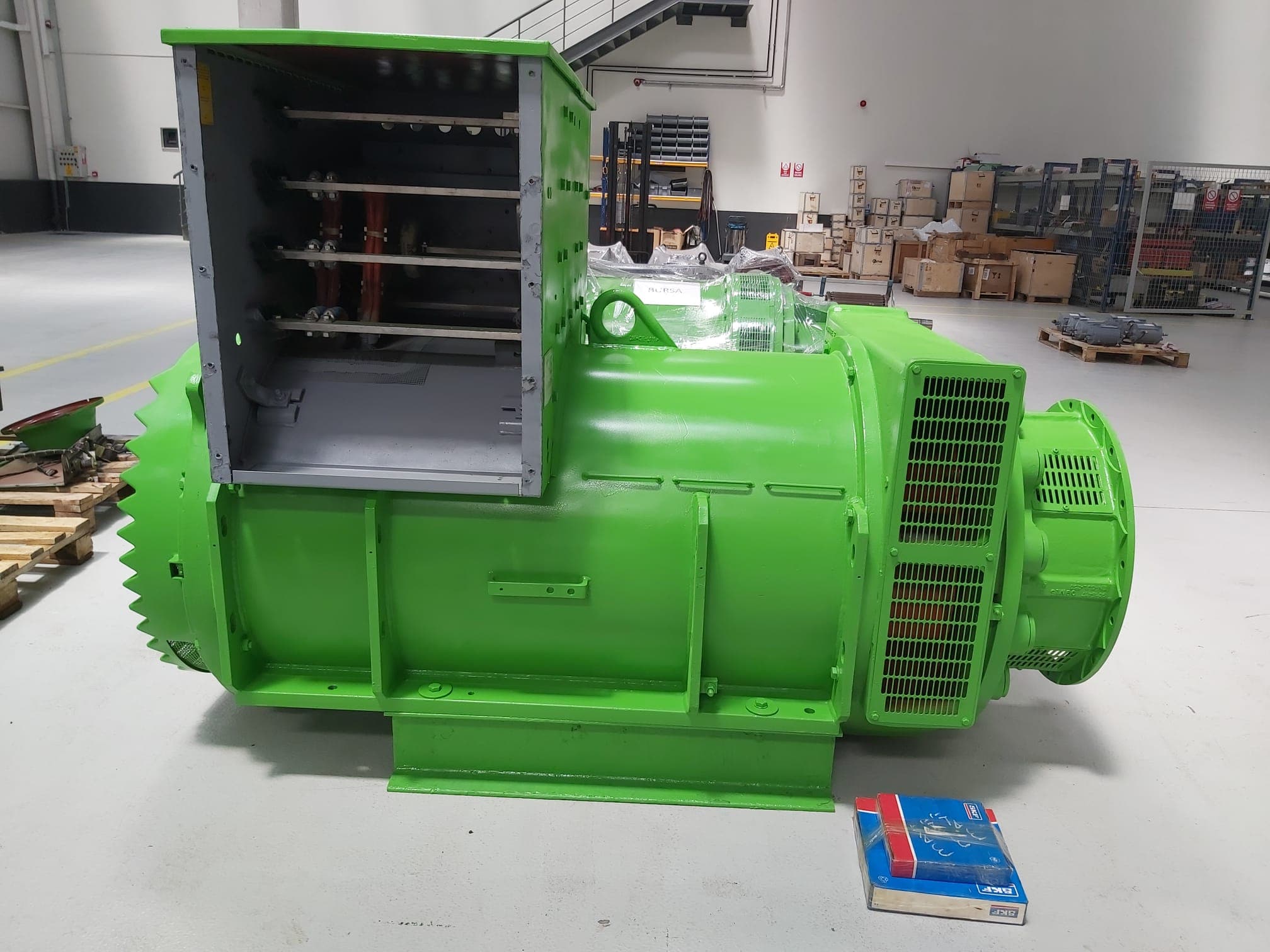 A green alternator with its terminal box open