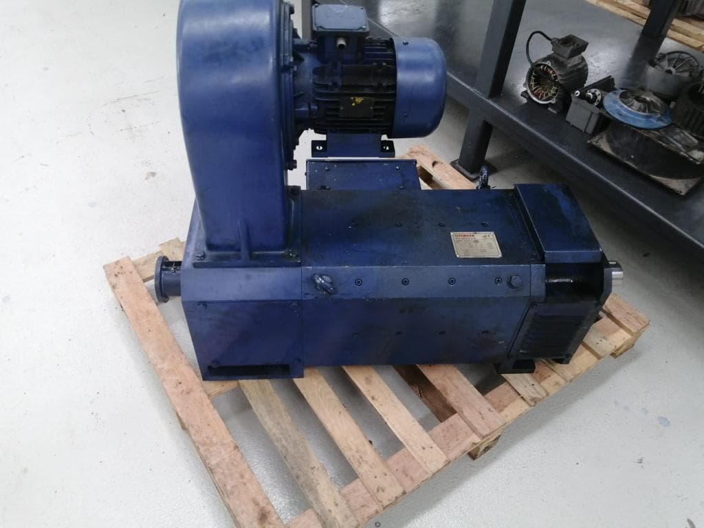 A blue motor with a blower fan on a pallet