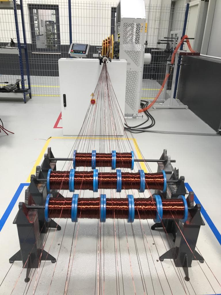Copper coils being prepared on the winding bench