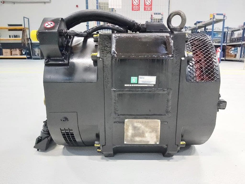 A grey traction motor with its cables
